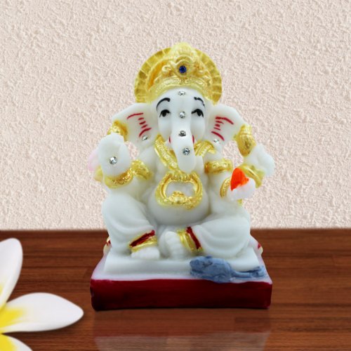 Car Dashboard Idols Lord Ganesha Sitting With Holding Red Modak in Hand White Color With Golden Ornaments Idol for Home Decor Home Decor Showpiece and Gifts by HomeDecorKart and Karigaari India