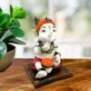 Little Lord Ganesha Sitting & Eating Laddu Idol Best for Home Decor