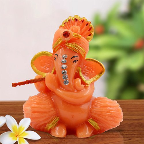 Unique Design Lord Ganesha Sitting And Playing Flute Idol Orange Color Best for Home Decor - Karigaari India Aesthetic Home Decor