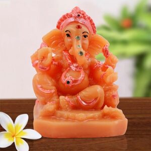 Small Unique Lord Ganesha Sitting With One Leg Down Idol Orange Color And Pink Ornaments Best for Home Decor - Karigaari India Aesthetic Home Decor