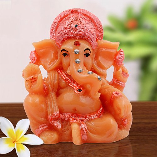 Unique Small Lord Ganesha Sitting With One Leg Up Idol Orange Color And Pink Ornaments Best for Home Decor - Karigaari India Aesthetic Home Decor