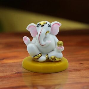 Lord Ganesha Sitting Idol With Holding Golden Modak Best for Home Decor - Karigaari India Aesthetic Home Decor