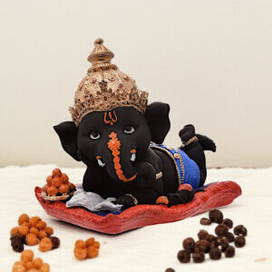 Peaceful Repose Ganesha: Intricately Crafted Resin Reclining Idol with Offerings - Spiritual & Serene - Karigaari India Aesthetic Home Decor
